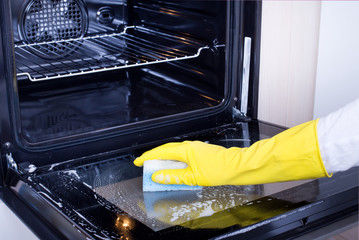 scrubbing inside of oven