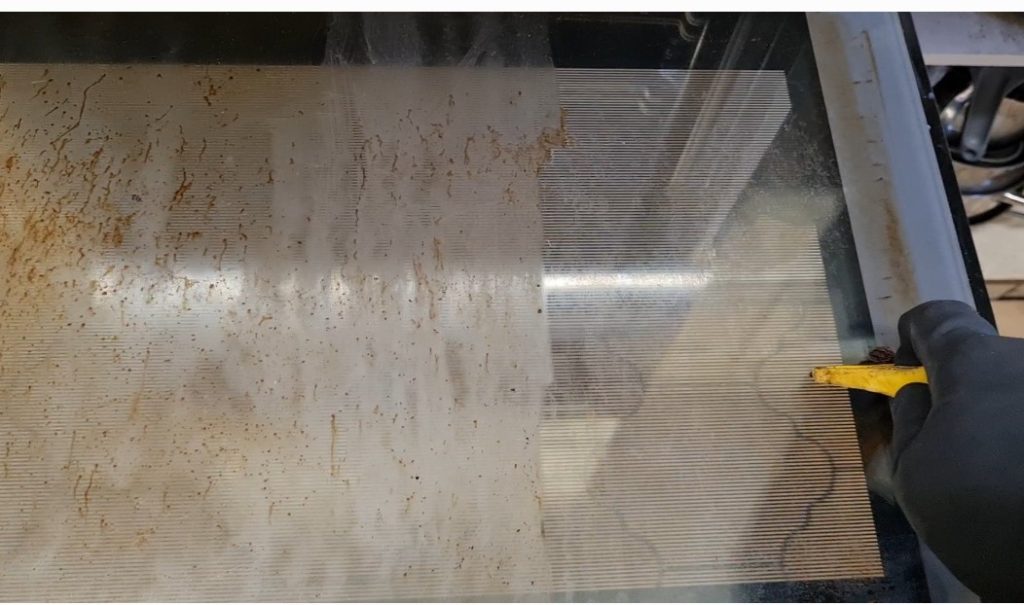 scraping oven door
