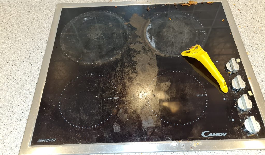 scraping a dirty hob