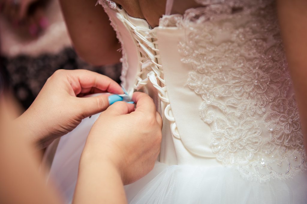 wedding dress being done up